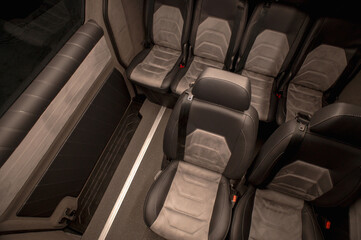 Obraz premium Comfortable interior of a passenger bus with soft seats. The design is made to order. Private covering of cars. Various elements of the bus interior.