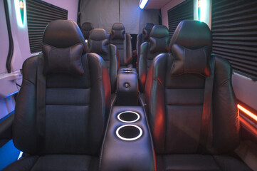 Comfortable interior of a passenger bus with soft seats. The design is made to order. Private...