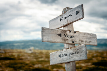 know your purpose text quote on wooden directional signpost outdoors in nature