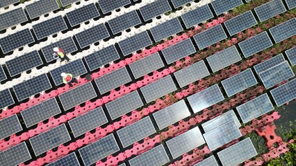 Male workers repair Floating solar panels on water lake. Engineers construct on site Floating solar panels at sun light. clean energy for future living. Industrial Renewable energy of green power.