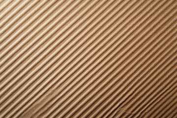Fototapeta premium Close-up of a brown corrugated cardboard texture with diagonal stripes, ideal for backgrounds, packaging design, and industrial material concepts.