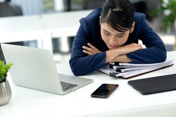 young businesswoman Wearing a suit bending over the table