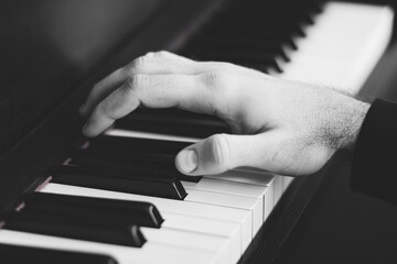 Obraz premium Black and white photograph of hands playing vintage piano