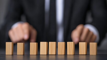 Business professionals protecting a line of wooden blocks, demonstrating risk control and strategic prevention methods