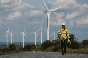 Man engineers holding tools box and rope to maintenance working in wind turbine. Renewable energy...