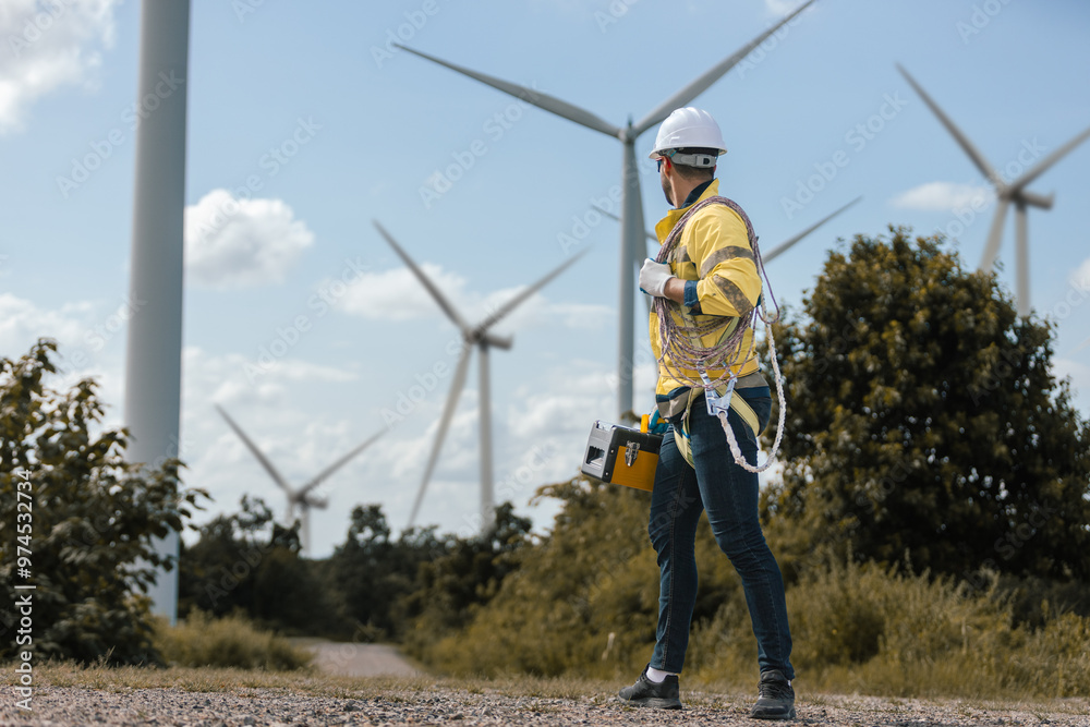 Poster Man engineers holding tools box and rope to maintenance working in wind turbine. Renewable energy power wind turbine. Technology protect environment reduce global warming problems.