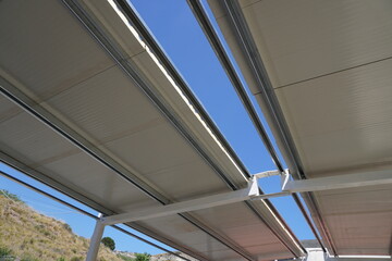 Obraz premium Industrial roofing made of sandwich panels. Composition of the building frame. Steel frame of the building. Modern construction of industrial buildings. Hangar construction 