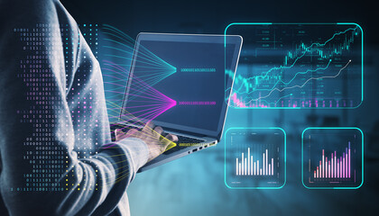 Person using laptop with financial data visualizations and binary code on a dark background.
