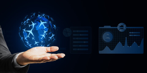 Hand presenting digital flight booking interface with world map and data charts on blue virtual background.
