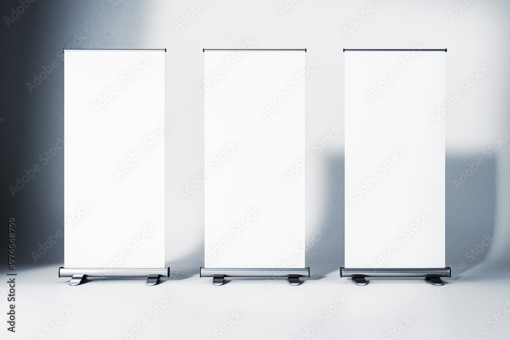 Poster Three blank roll-up banners in a studio with gradient background. 3D Rendering