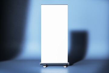 Blank roll-up banner mockup on gradient blue background in studio light. 3D Rendering