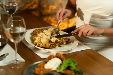 Woman Enjoys Crispy Dish at Outdoor Restaurant