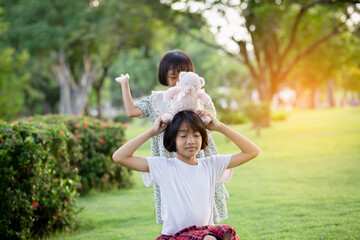 Obraz premium Two young girls are hugging each other in a park