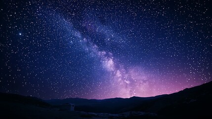 Fototapeta premium The Milky Way stretches across a night sky, silhouetted by towering mountains, creating a breathtaking, serene view.