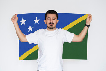 Moustached man holding Solomon Island flag, independence or celebration day idea, campaigning 
