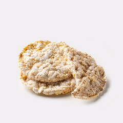 Cereal cakes on a white background. These cakes are commonly used as a substitute for bread or as a light snack, perfect for pairing with both sweet and savory ingredients.