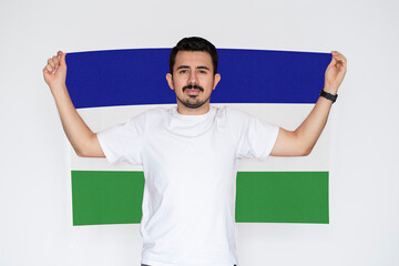 Moustached man holding Lesotho flag, independence or celebration day idea, campaigning concept