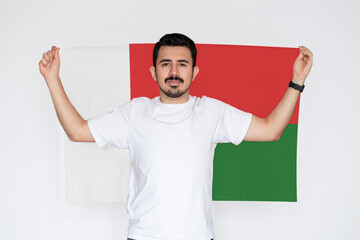 Moustached man holding Madagascar flag, campaigning concept, patriot and nationalist person