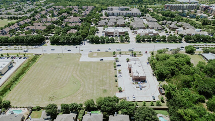 Obraz premium Large vacant land near Keller Parkway, Farm to Market Road 1709 in downtown Keller in fast-growing mixed-use development area of residential houses, commercial buildings, restaurant, aerial view