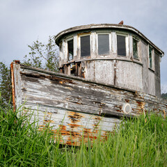 Old abandon ship in a grass field