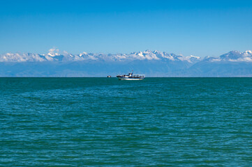 Panoramic view of Lake Issyk-Kul in Kyrgyzstan.A pleasure boat on the horizon.