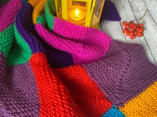 Crochet blanket and candle flashlight with autumn objects cozy fall season photo