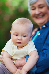 Outdoor, baby and grandma with smile for love, connection and bonding together with happiness. Senior person, grandmother and little boy with trust in garden for childcare, development and growth