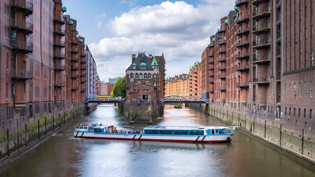 Hamburg, Germany, view of Speicherstadt in Hamburg, Germany. Time-lapse with illuminated historical buildings at sunset with reflection in the water, panning video