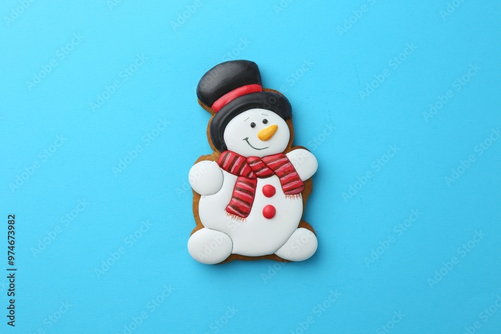 Sticker Tasty Christmas cookie in shape of snowman on light blue background, top view