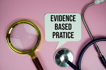 Evidence based pratice text with stethoscope and magnifying glass on pink background, Healthy and wellness concept
