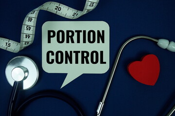 Portion Control text on speech bubble with measure tape and stethoscope on navy blue background,...