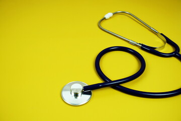 Stethoscope medical equipment isolated on yellow background