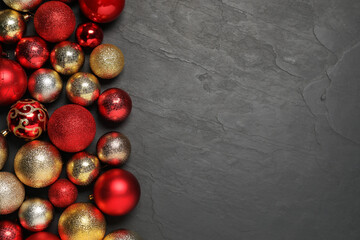 Different Christmas balls on grey textured background, flat lay. Space for text