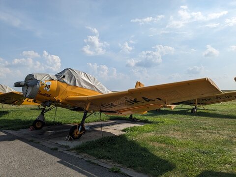 Jihlava,May 4 2025:Yellow agricultural spray plane Zlin Z-37 Cmelak captured on the ground, highlighting its rugged fuselage, wide wings, and utilitarian crop-dusting design in clear daylight.