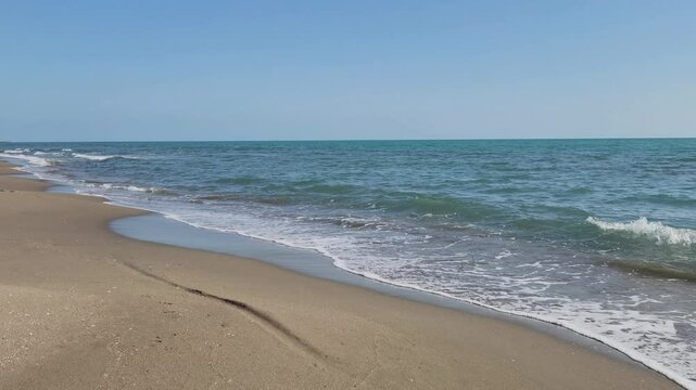 Sea waves and beach on the Mediterranean coast with sea, sand and sun for summer holidays