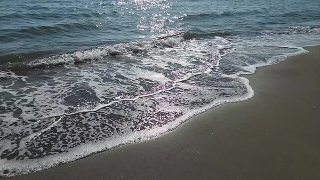 Sea waves and beach on the Mediterranean coast with sea, sand and sun for summer holidays