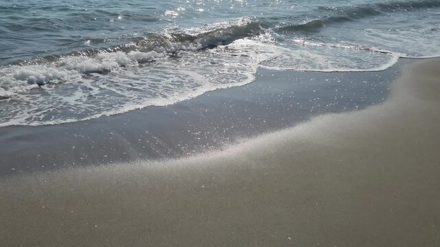 Sea waves and beach on the Mediterranean coast with sea, sand and sun for summer holidays