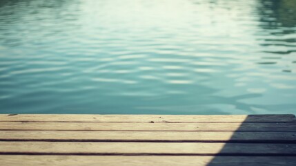 A serene view of a wooden dock extending over calm water, reflecting the peaceful environment.