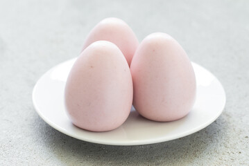 Raspberry cream mousse dessert egg. On a plate. Close-up