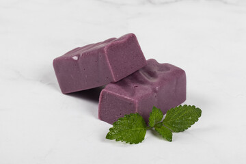 Black grape nougat. White background. Close-up