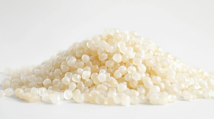 A pile of small, translucent beads resembling wax or resin.