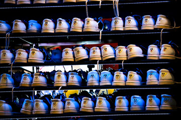 Bowling shoes rack with different sizes. Blue lighting.