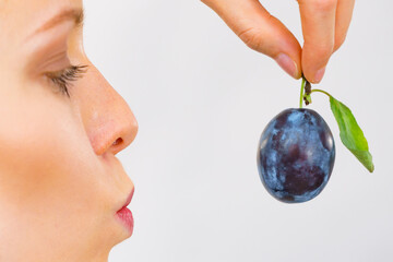 Girl holds plum fruit