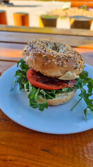 Breakfast bagel overlooking canadian mountains in summer.
