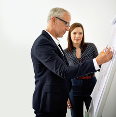 Business people, man and woman with whiteboard, coaching and planning for project. Employees, mentor and consultant with ideas, brainstorming or cooperation for proposal, feedback or review in office