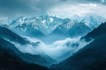 Majestic Snow-capped Mountain Range with Mist and Terraced Hillsides