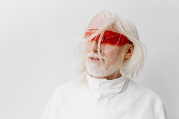 elderly man with long white hair and glasses, wearing a white coat against a white background,...