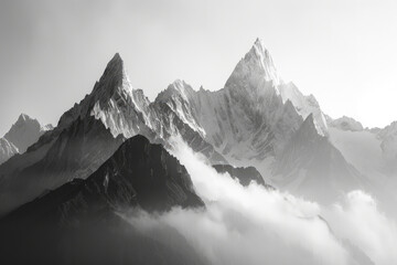 Majestic Snow-Capped Mountain Peaks Shrouded in Mist and Clouds in Black and White