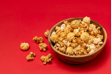 Caramel popcorn on a red background