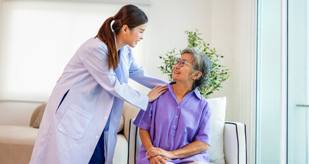 woman in a purple shirt is sitting on a couch while a woman in a white coat is